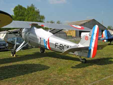 Morane Saulnier in front of hangars at La Ferte Alais