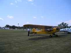 Jack ties the Cub down in Vintage Aircraft Parking Oshkosh Jack ties the Cub down in Vintage Aircraft Parking Oshkosh